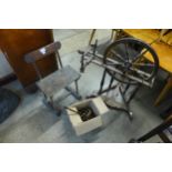 A vintage child's toy spinning wheel and a chair