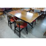 A G-Plan Librenza tola wood and black spider leg dining table and four butterfly back chairs