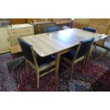 A Gordon Russell walnut extending dining table and four chairs