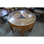 A Nathan teak and glass topped circular nest of tables