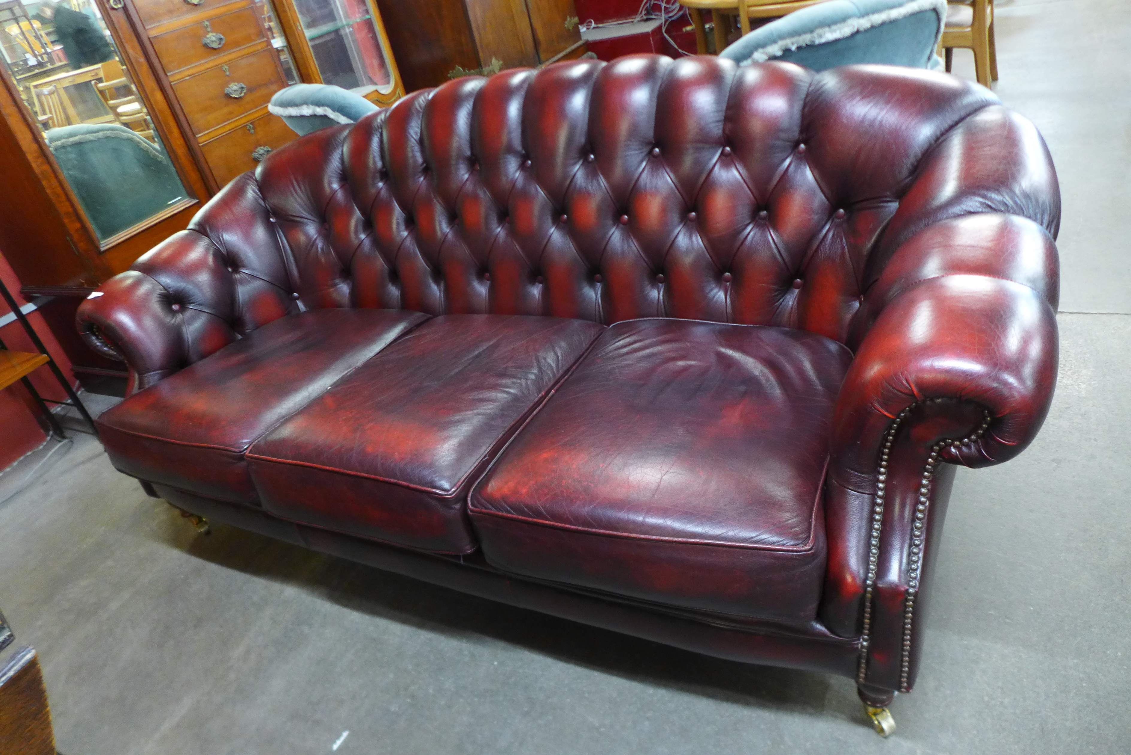 A red leather Chesterfield style settee
