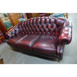 A red leather Chesterfield style settee