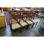 A set of eight Arts and Crafts oak rush seated chairs