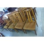 A set of four Nathan teak dining chairs