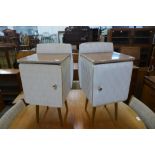 A pair of simulated walnut and white vinyl bedside cabinets