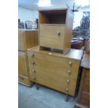 A teak chest of drawers and a bedside cabinet