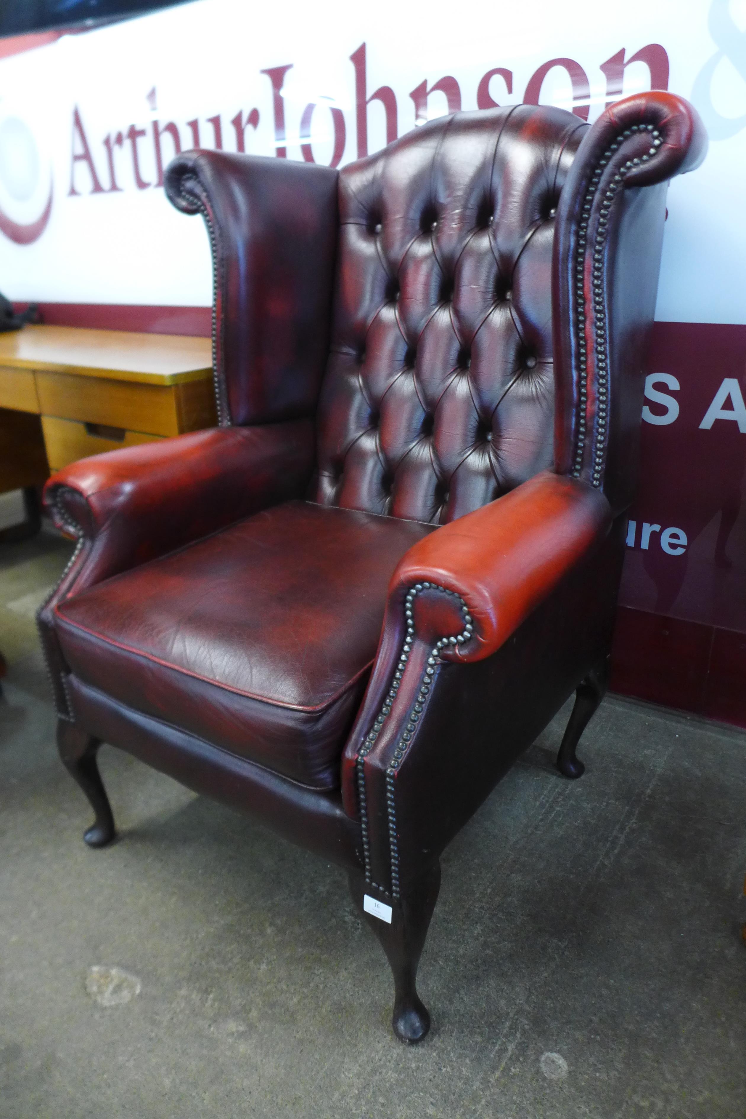 A red leather Chesterfield wingback armchair