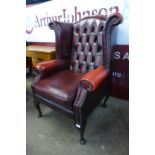 A red leather Chesterfield wingback armchair