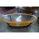 A teak and glass topped oval coffee table