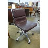 An Eames style chrome revolving desk chair