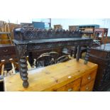 A Victorian Jacobean Revival carved oak window seat