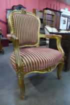 A French Louis XV style giltwood and fabric upholstered fauteuil armchair