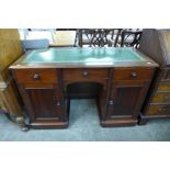 A Victorian mahogany and green leather topped kneehole desk