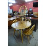 An Ercol Blonde elm and beech oval table and four Ercol Windsor chairs