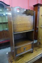 An early 20th Century oak newspaper stand
