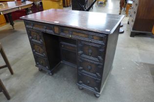 A Jacobean Revival oak geometric moulded kneehole desk
