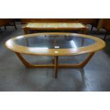 A teak and glass topped oval coffee table