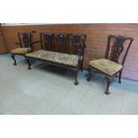A Chippendale style carved mahogany chair back settee and a pair of side chairs