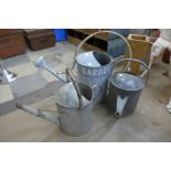 Three galvanised watering cans