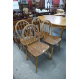 A set of four Ercol elm and beech Windsor chairs