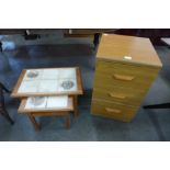 A small teak chest of drawers and a teak and tiled topped nest of two tables