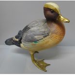 A wooden model of a Mallard Duck with brass feet and bill