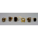 Six gilt rings, including smoky quartz and onyx set, one marked 925, one marked silver and one