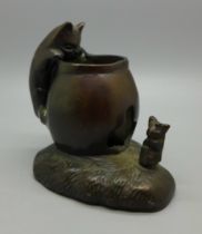 A small bronze candle holder, 7.5cm