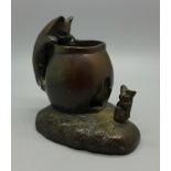 A small bronze candle holder, 7.5cm