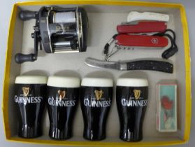 Two pairs of Guinness salt and pepper pots, a fishing reel and four pocket knives