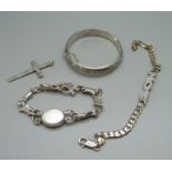 Two silver bracelets, a hallmarked silver cross pendant and a silver bangle, bangle dented, 63g