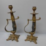 A pair of novelty sword hilt candlesticks