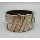 A Victorian bangle with gold applied decoration, 31mm wide, opening 46mm x 55mm