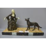 A spelter bronzed figure of a woman and a German Shepherd on an Art Deco marble stand