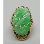 A 14k gold and carved jade ring, 6.4g, L