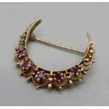 A 9ct gold, ruby set crescent brooch, 4g