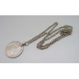 A mounted Marie Theresia silver coin on white metal chain