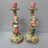A pair of continental figural candlesticks
