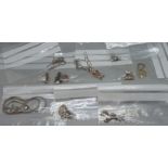 Ten silver pendants and chains