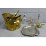 A brass coal scuttle, a silver plate on copper candelabra, plated sauce boat and tray **PLEASE