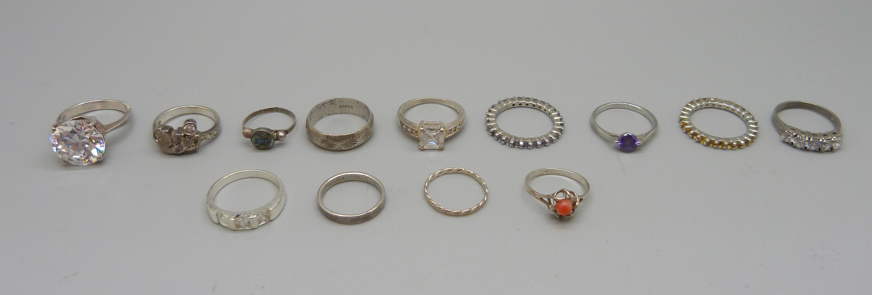 Nine silver rings and four other rings