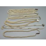 Six faux pearl necklaces including five with silver clasps