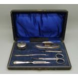 A silver manicure set, (nail buffer dented)