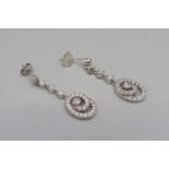 A pair of 9ct white gold and diamond pendant earrings, set with 52 diamonds in total
