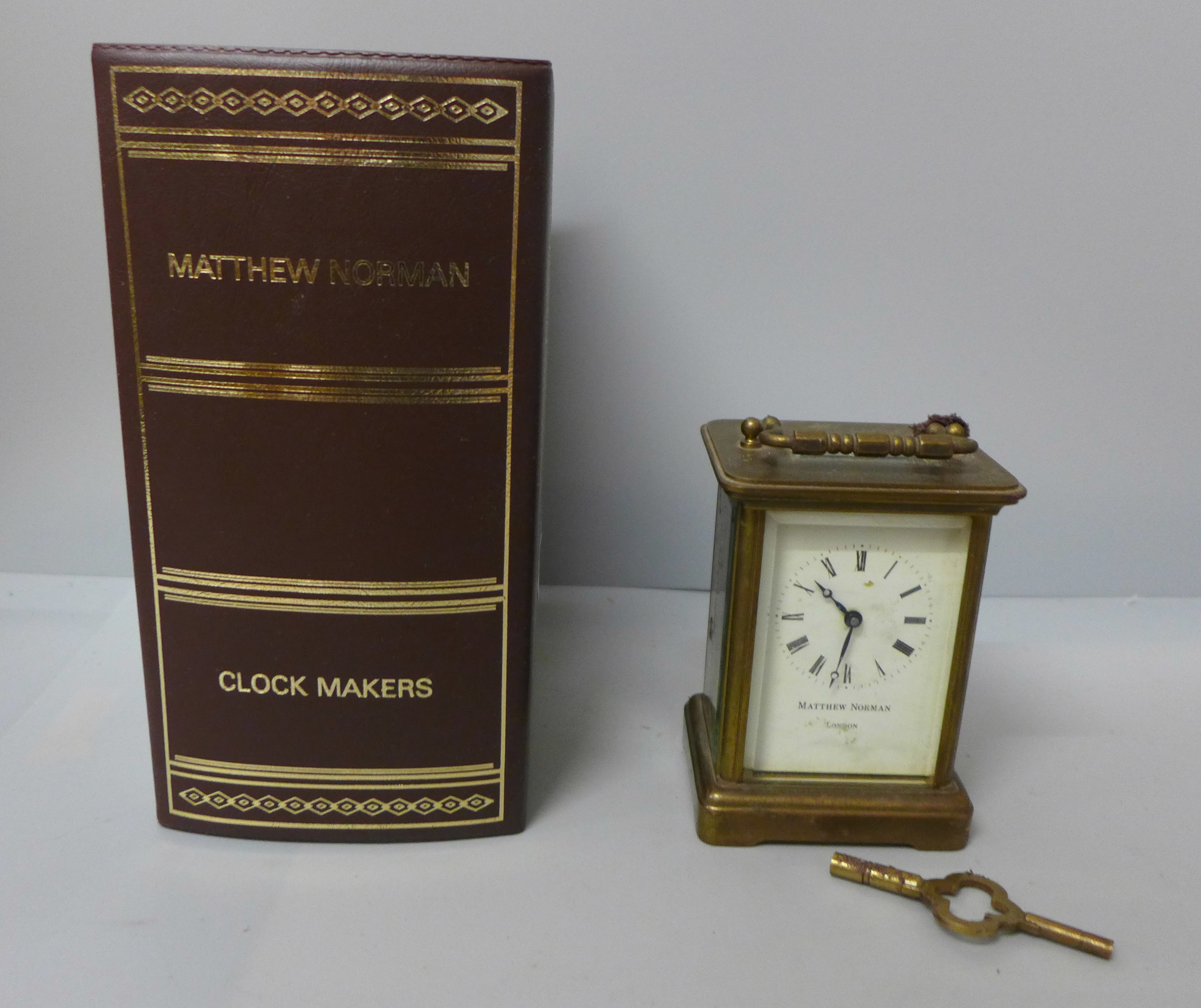 A Matthew Norman four glass sided brass timepiece, boxed