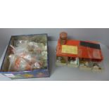 An eight drawer plastic cabinet with sorted foreign coins and a tin of coins