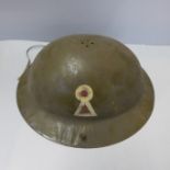 A child's size military helmet with key hole insignia, no liner