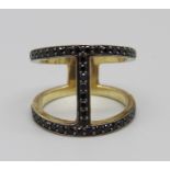 A silver gilt, two row black spinel ring, M