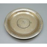 A white metal dish set with a Middle Eastern coin, 62g, 108mm