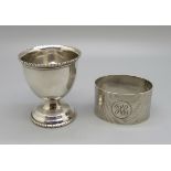 A silver egg cup and a silver napkin ring, 48g